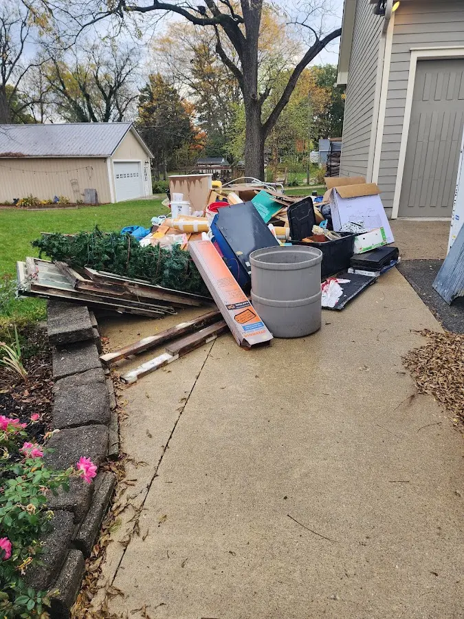 Dumpster being loaded with debris for Estate Cleanout Dumpster Rental in Oakdale